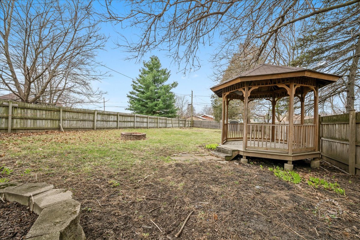 506 North Garfield Street Lombard, IL 60148 - Photo 29 of 40 a view of a yard with a wooden fence and a large tree
