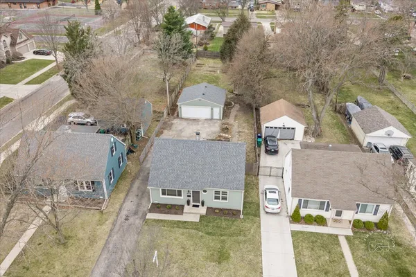 an aerial view of residential houses with outdoor space