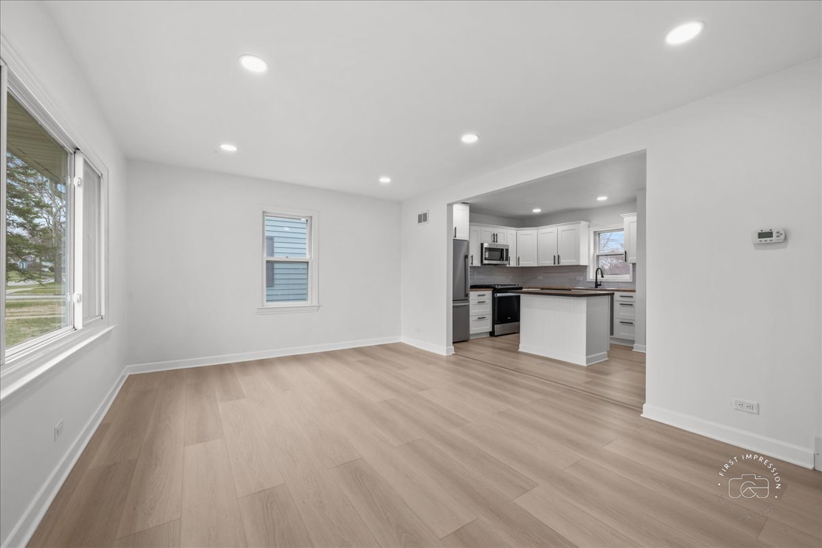 506 North Garfield Street Lombard, IL 60148 - Photo 5 of 40 an empty room with wooden floor and windows