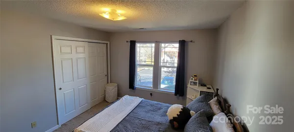 a bed room with a bed and a window