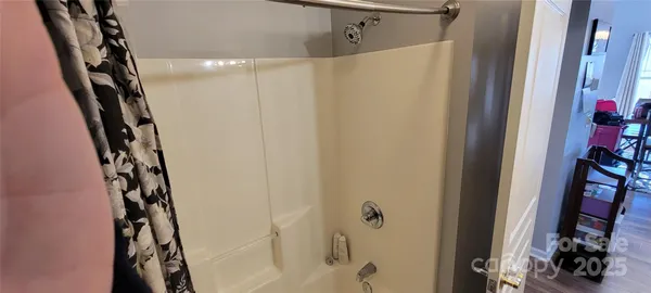a bathroom with a shower and a sink
