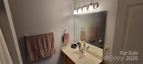 a bathroom with double vanity sink and two mirror