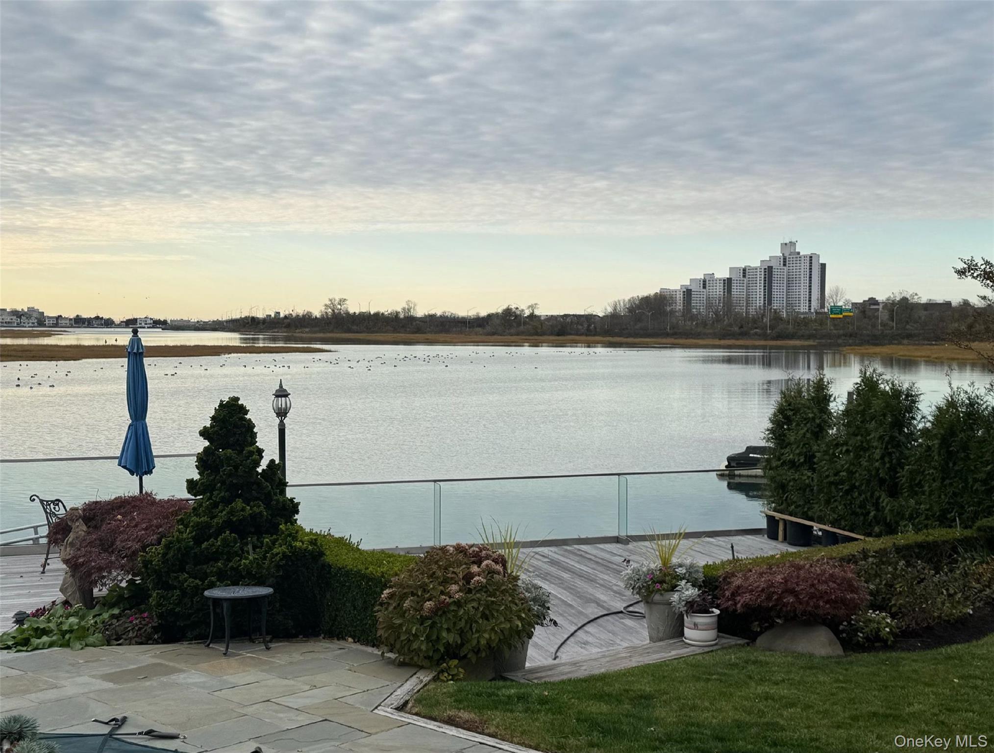 49 Harborview West Lawrence, NY 11559 - Photo 7 of 7 a view of a lake with a garden