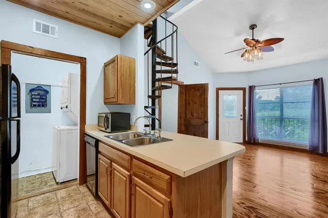 a kitchen with a sink a stove and a refrigerator