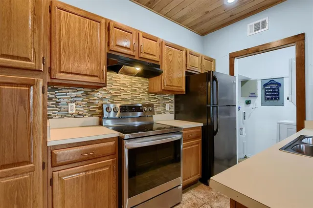 a kitchen with stainless steel appliances a refrigerator stove and sink