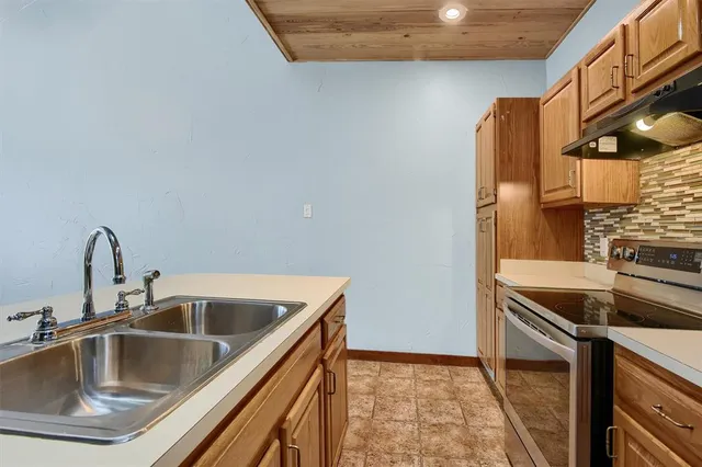 a kitchen that has a sink and a stove
