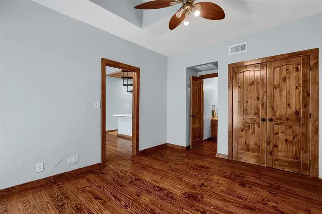 a view of an empty room with wooden floor