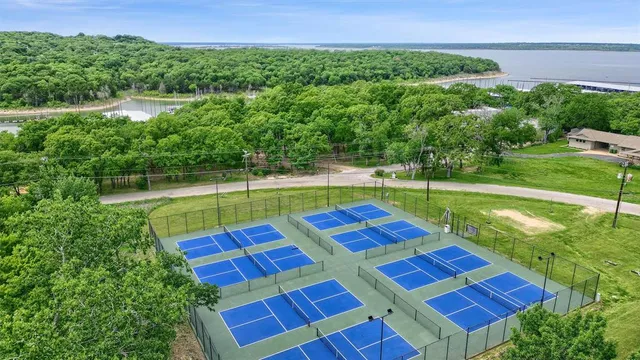 a aerial view of a tennis ground with a big yard