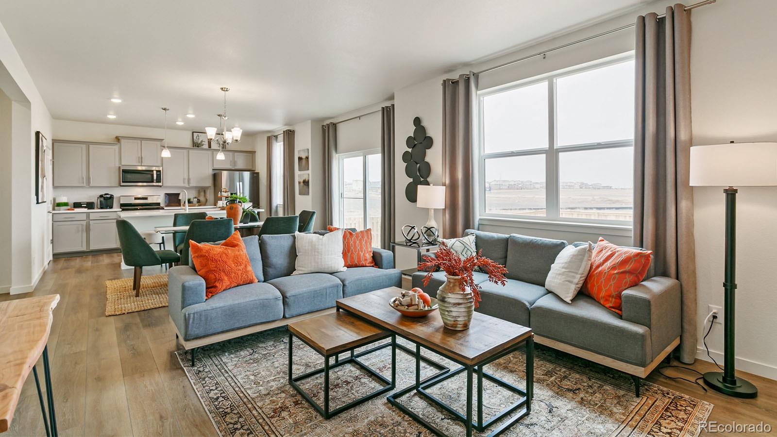 801 South Apex Avenue Fort Lupton, CO 80621 - Photo 14 of 26 a living room with furniture and a large window