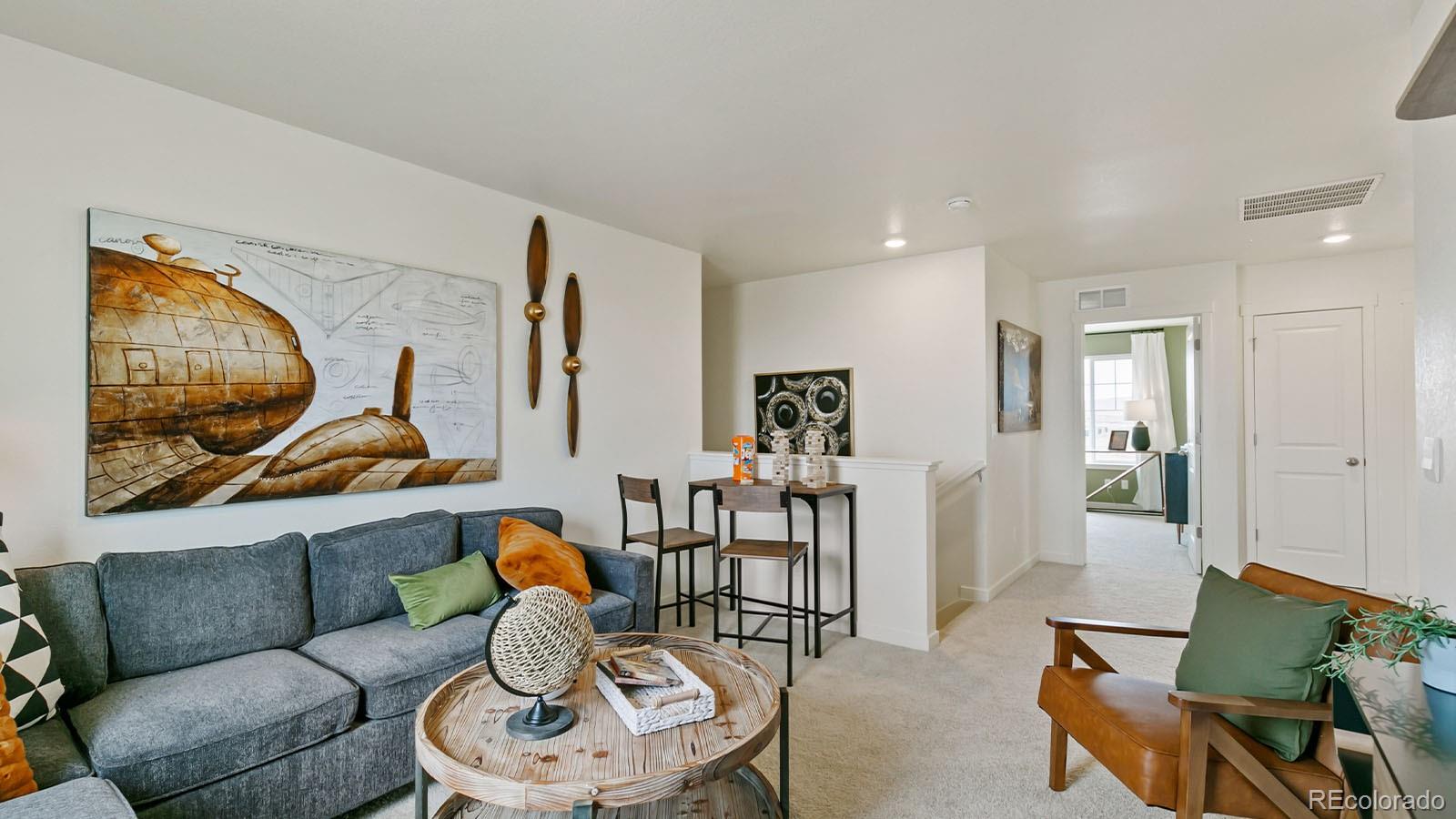 801 South Apex Avenue Fort Lupton, CO 80621 - Photo 17 of 26 a living room with furniture and wall paintings