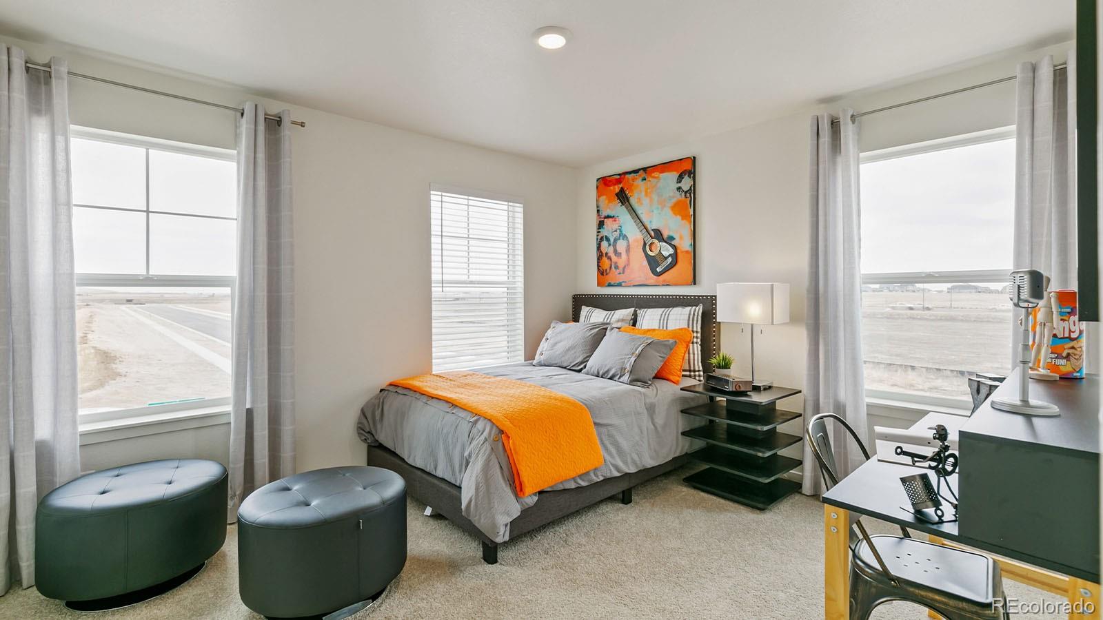 801 South Apex Avenue Fort Lupton, CO 80621 - Photo 20 of 26 a bedroom with a bed and a large window