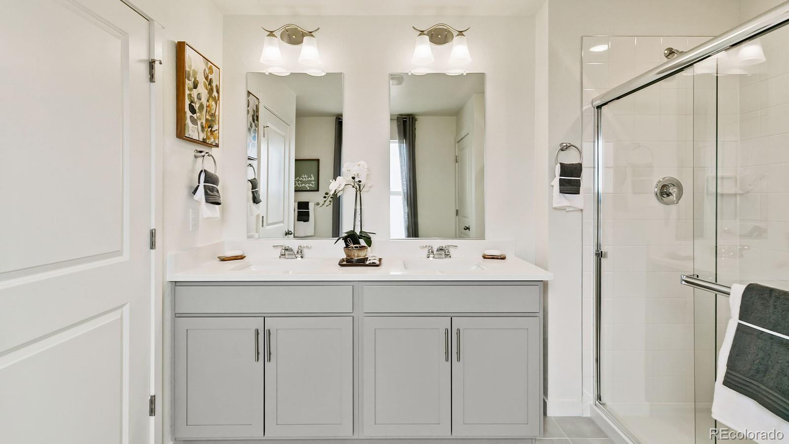 801 South Apex Avenue Fort Lupton, CO 80621 - Photo 22 of 26 a bathroom with a double vanity sink mirror and double