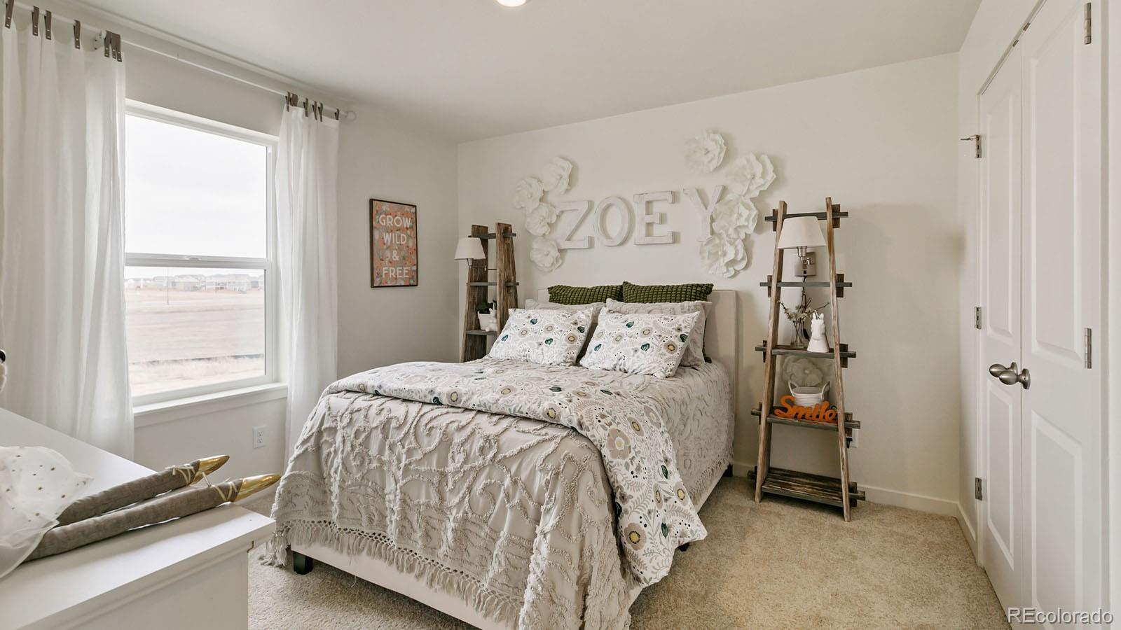 801 South Apex Avenue Fort Lupton, CO 80621 - Photo 23 of 26 a bedroom with a bed and a window