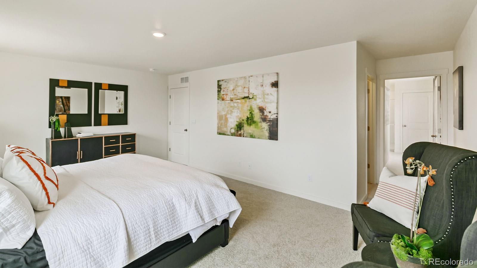 801 South Apex Avenue Fort Lupton, CO 80621 - Photo 24 of 26 a bedroom with a bed table and dresser