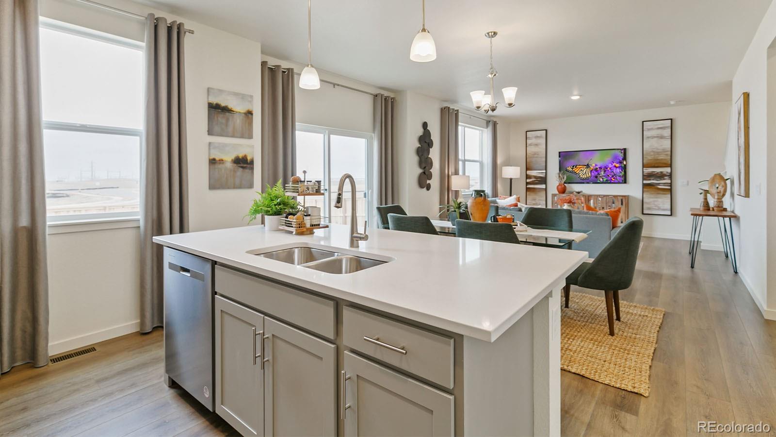 801 South Apex Avenue Fort Lupton, CO 80621 - Photo 4 of 26 a view of kitchen island a sink and living room