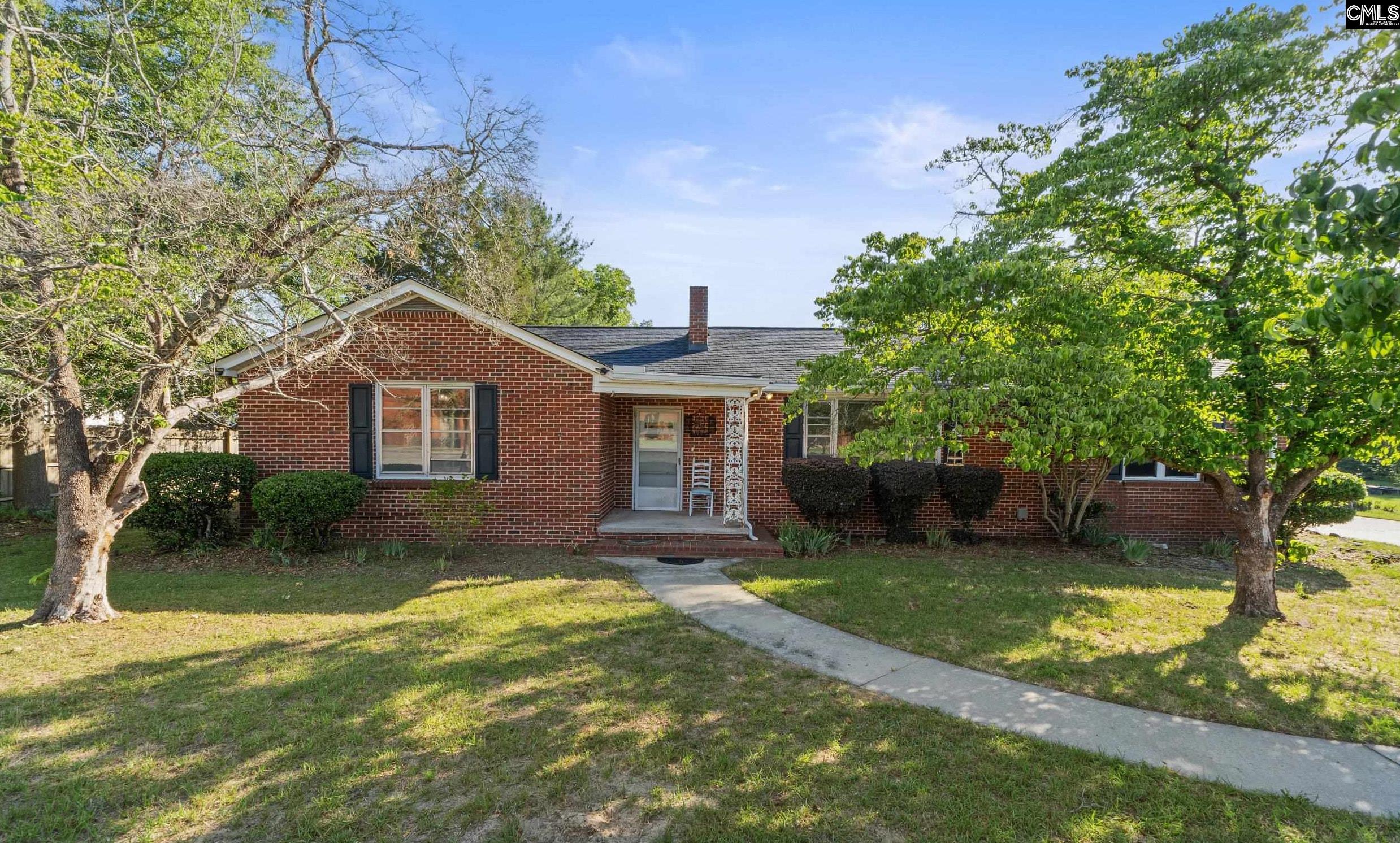 729 Magnolia Street Pelion, SC 29123 - Photo 1 of 32 a view of a house with a yard and large tree