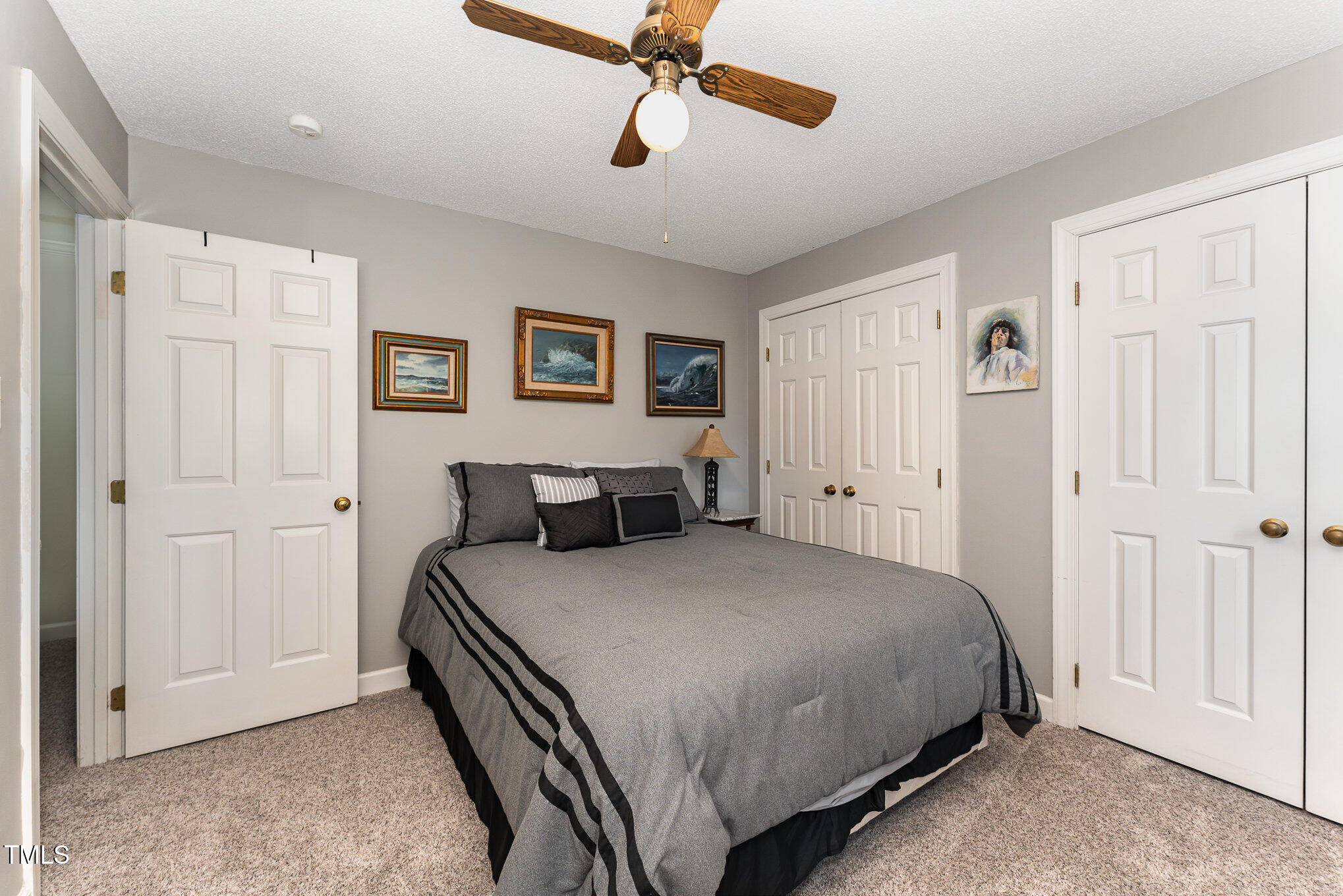 4217 Pike Road Raleigh, NC 27613 - Photo 16 of 22 a spacious bedroom with a bed and a chandelier