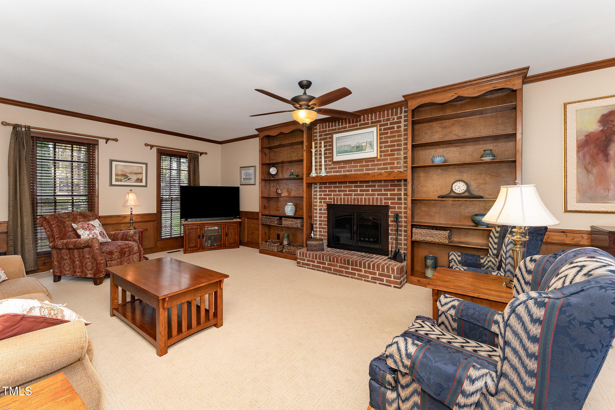 4217 Pike Road Raleigh, NC 27613 - Photo 6 of 22 a living room with furniture a flat screen tv and a fireplace