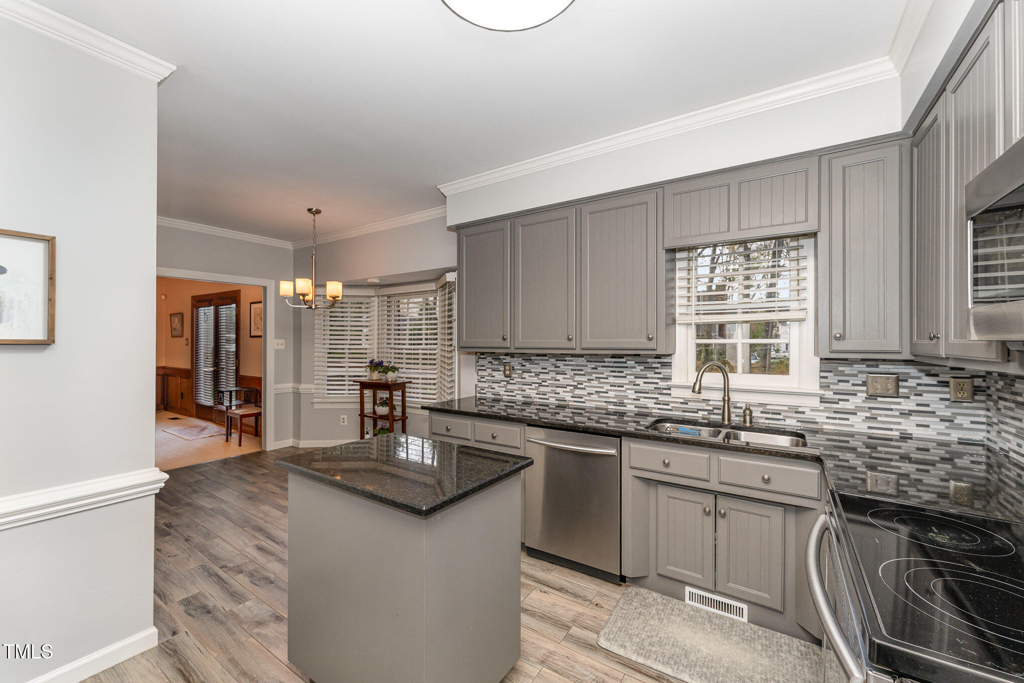 4217 Pike Road Raleigh, NC 27613 - Photo 9 of 22 a kitchen with stainless steel appliances granite countertop a sink stove and cabinets