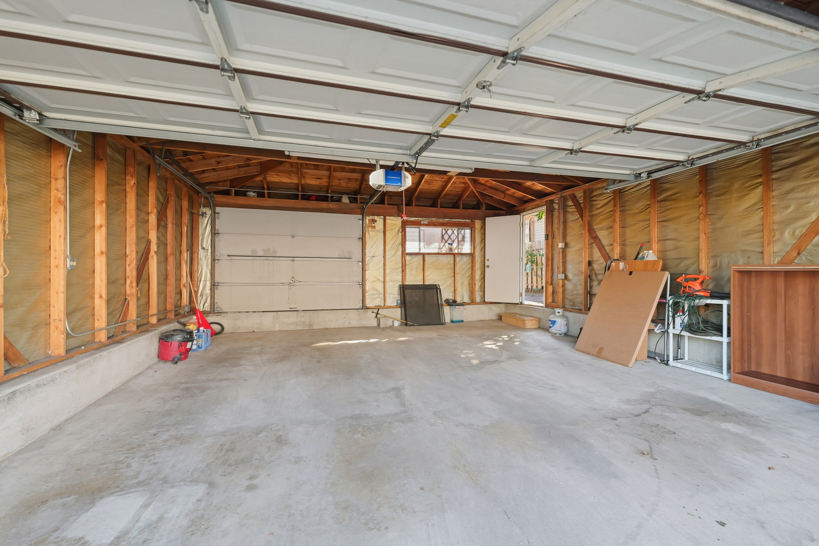 9020 South Constance Avenue Chicago, IL 60617 - Photo 21 of 26 a view of a room with wooden walls and a window