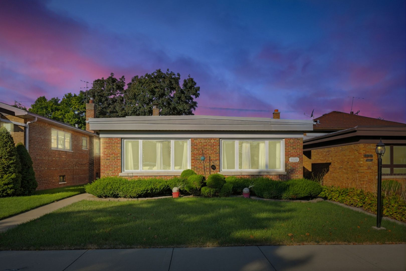 9020 South Constance Avenue Chicago, IL 60617 - Photo 22 of 26 a front view of a house with a garden