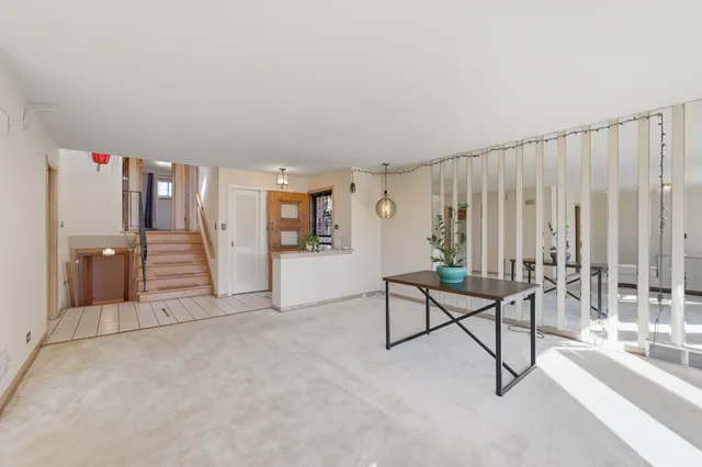 a view of a livingroom with furniture and stairs