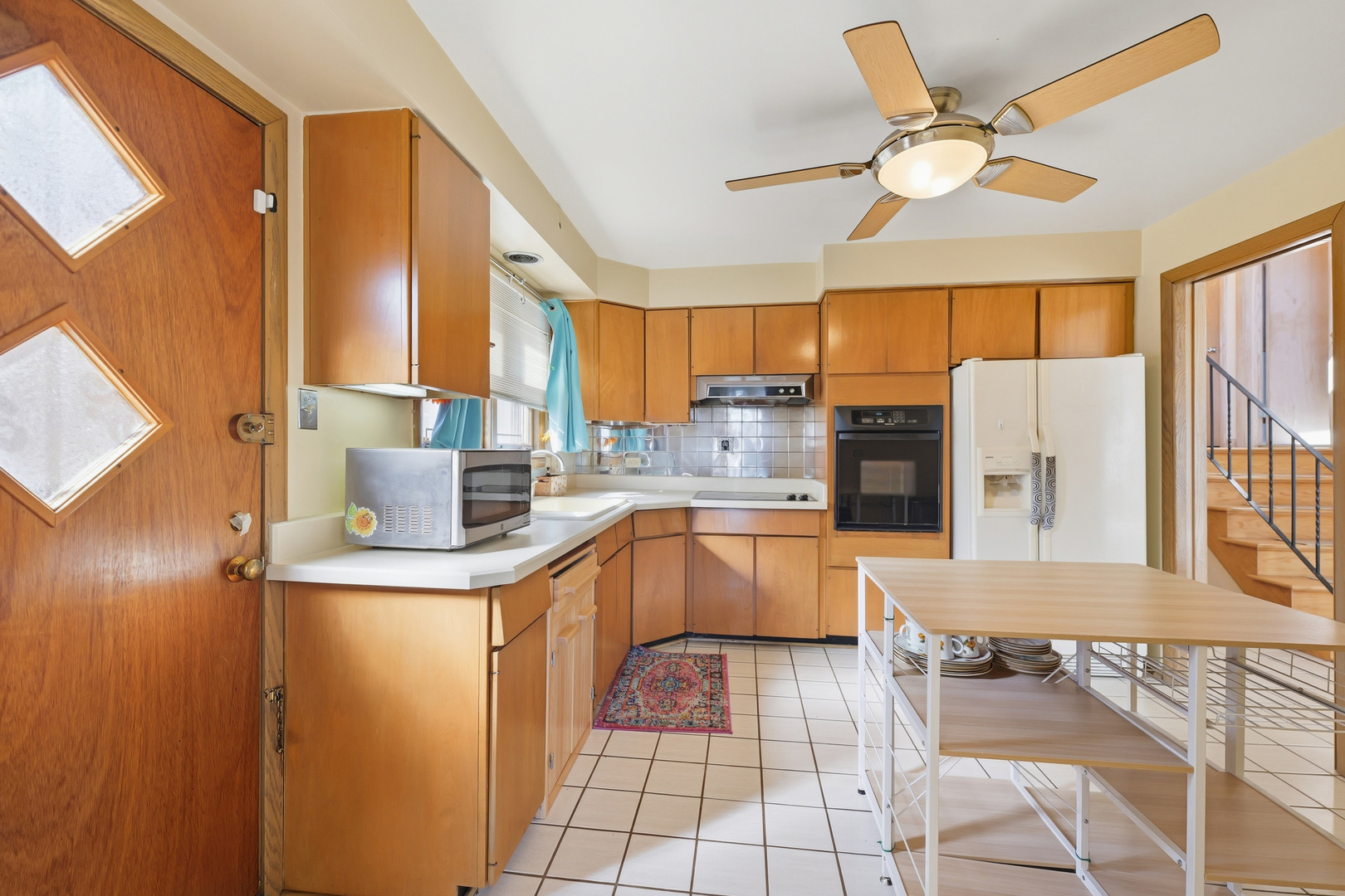 9020 South Constance Avenue Chicago, IL 60617 - Photo 5 of 26 a kitchen with stainless steel appliances a stove a sink and a refrigerator