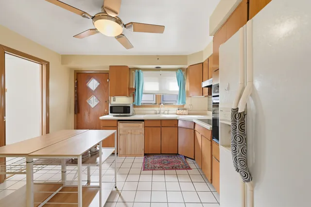 a kitchen with a sink appliances and cabinets