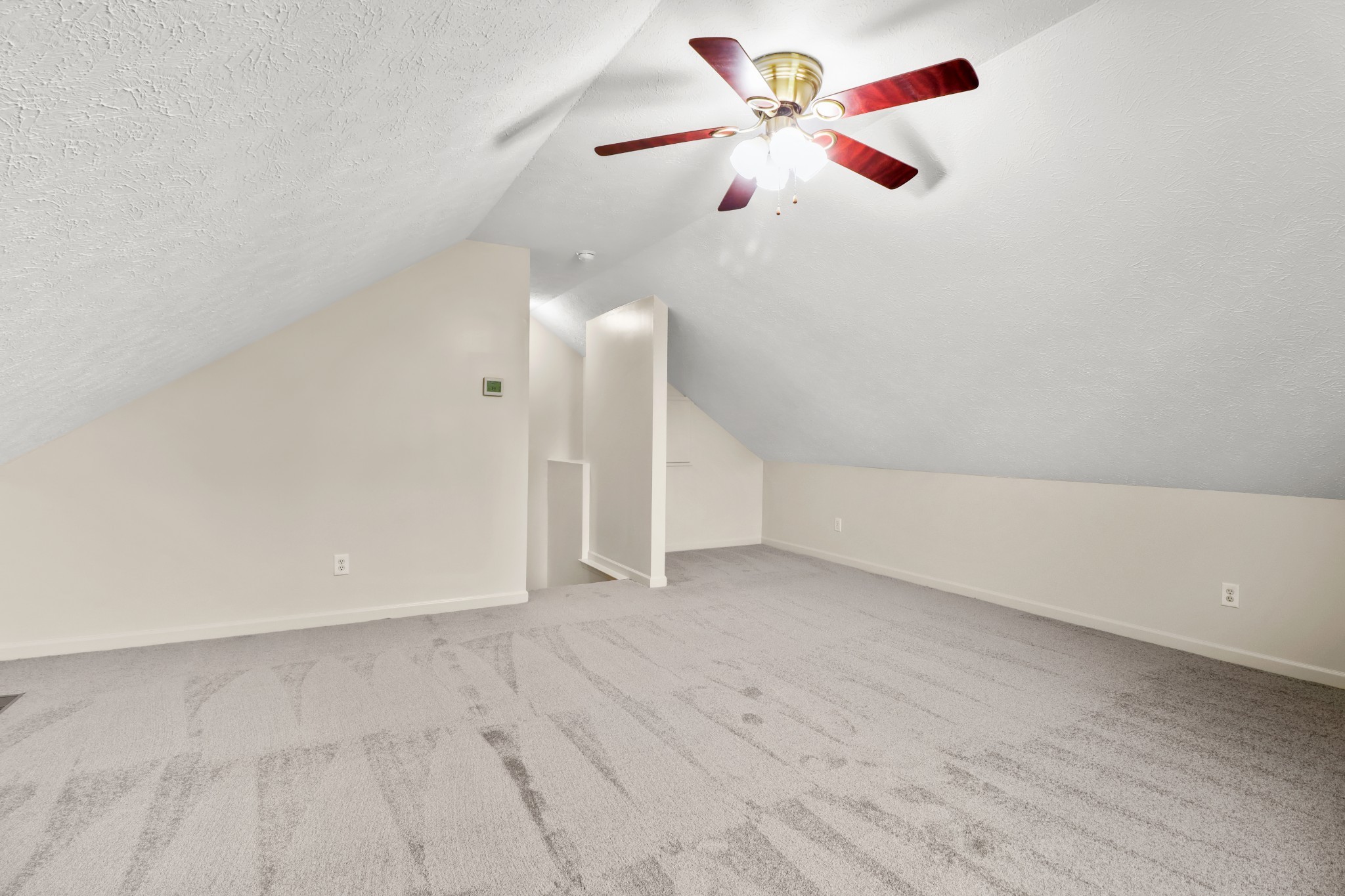 4591 Washington Road Greenbrier, TN 37073 - Photo 11 of 14 an empty room with chandelier fan and wooden floor