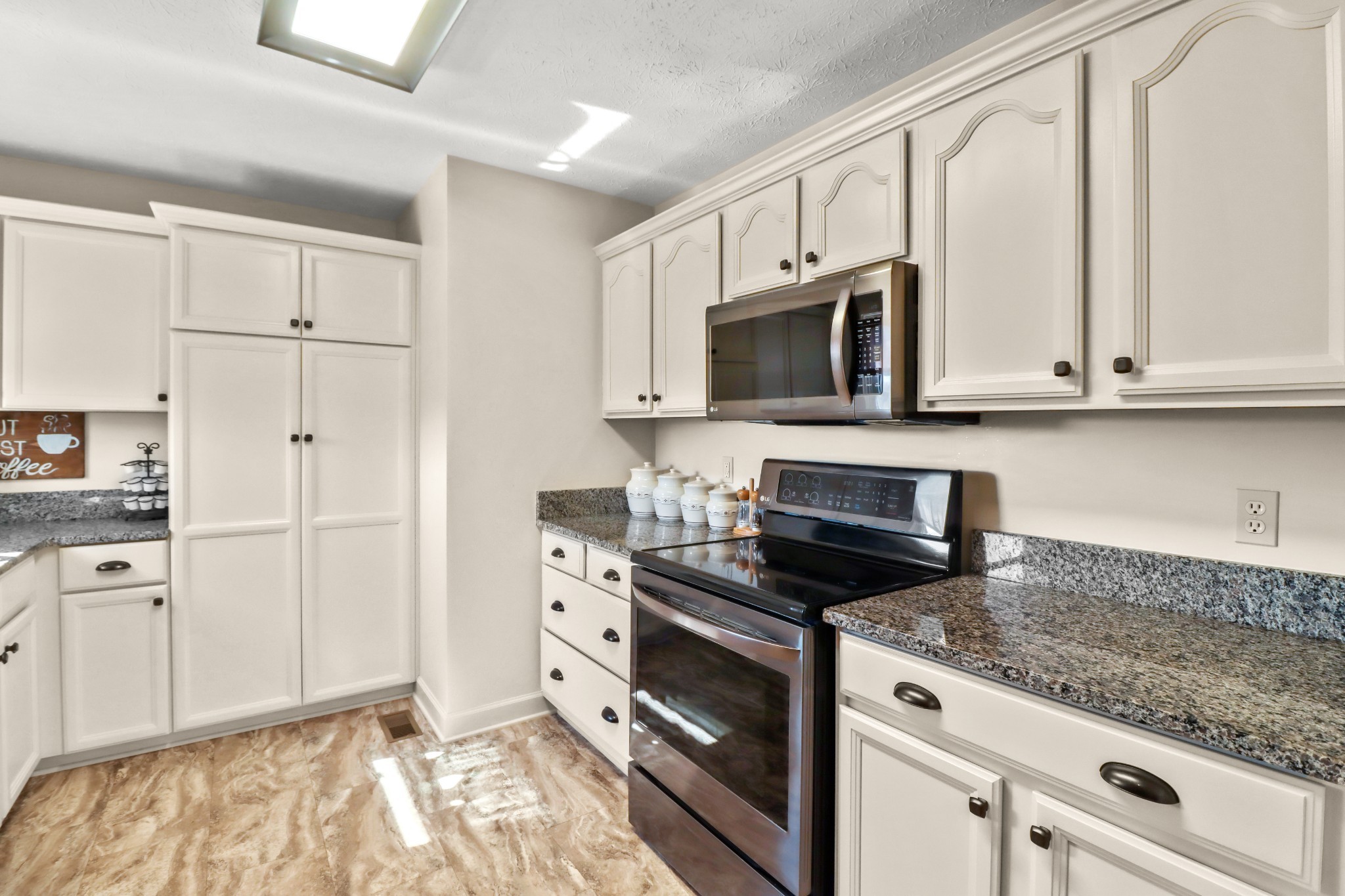 4591 Washington Road Greenbrier, TN 37073 - Photo 2 of 14 a kitchen with granite countertop white cabinets and stainless steel appliances