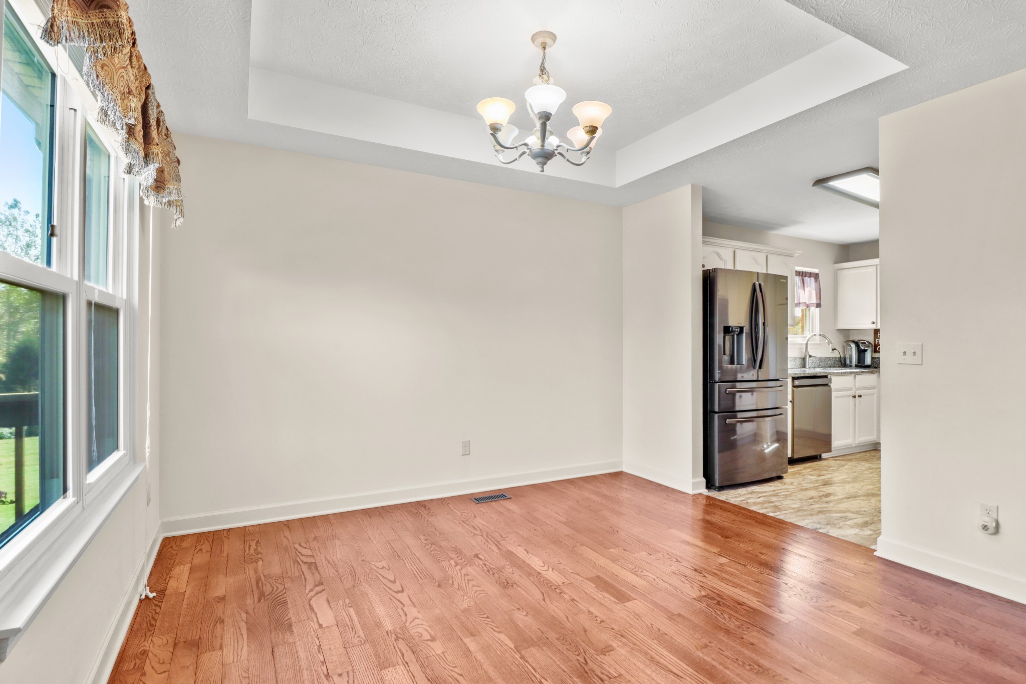 4591 Washington Road Greenbrier, TN 37073 - Photo 4 of 14 a view of a kitchen with wooden floor and a kitchen