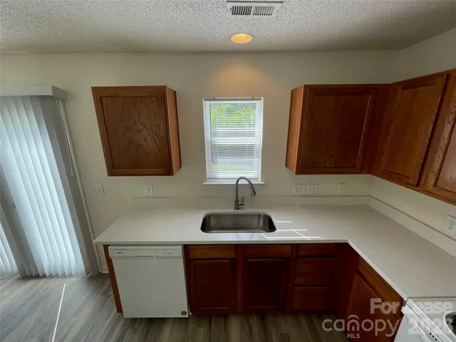 a kitchen with a sink and a mirror