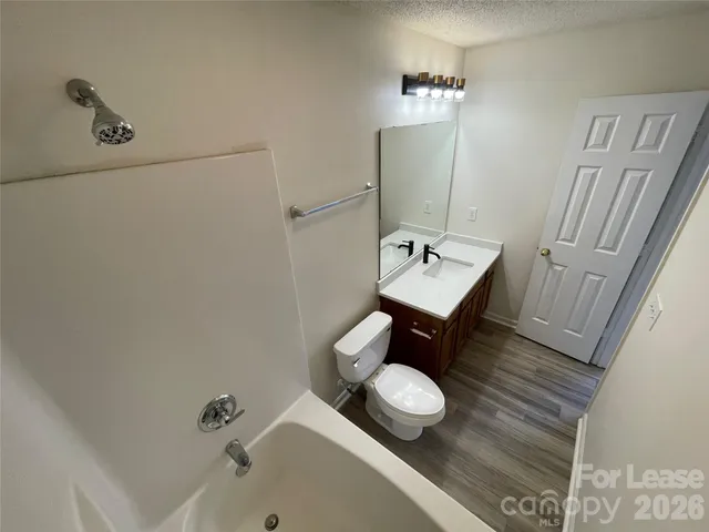 a bathroom with a sink toilet and tub