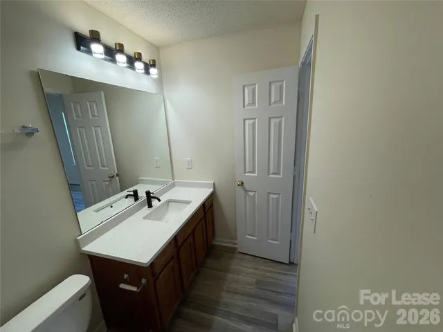 a bathroom with a sink vanity and mirror