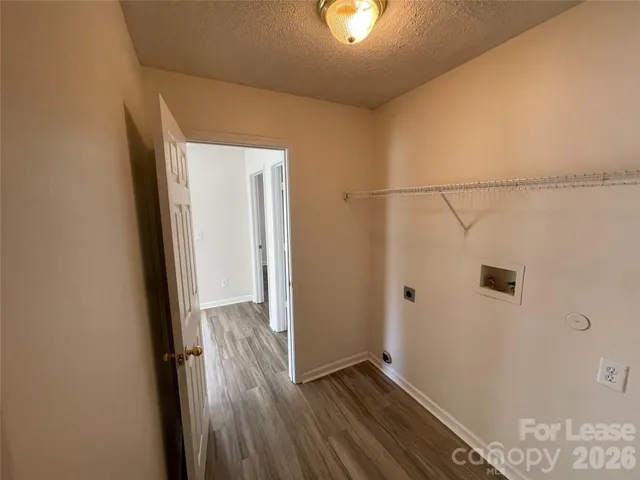 a view of hallway with wooden floor