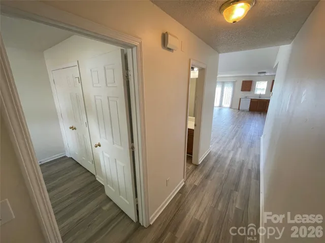 a view of a hallway with wooden floor