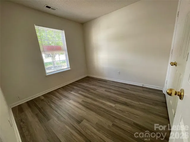 a view of room with window and hardwood floor