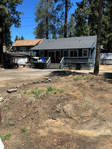 a front view of a house with yard and porch