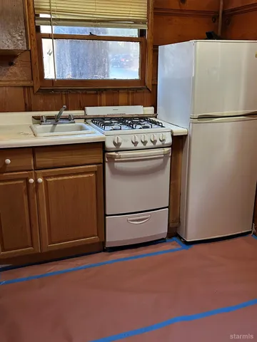 a kitchen with a stove and a refrigerator