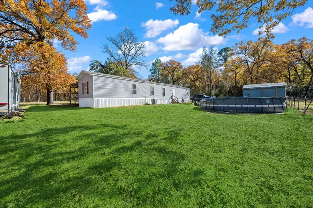 a view of outdoor space with swimming pool and trees