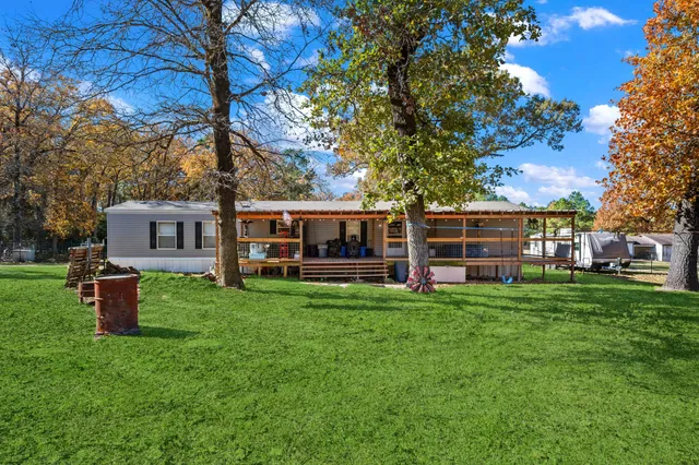 a view of a house with a backyard