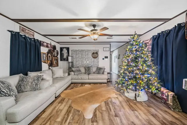 a living room with furniture and a chandelier