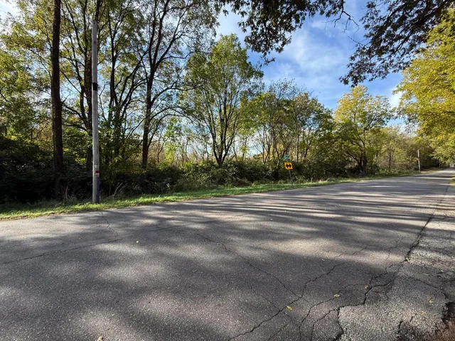 a view of a house with a yard and trees