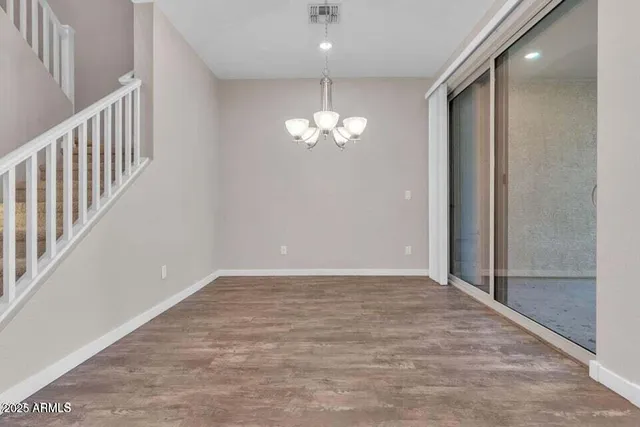 a kitchen with granite countertop stainless steel appliances a sink stove and refrigerator