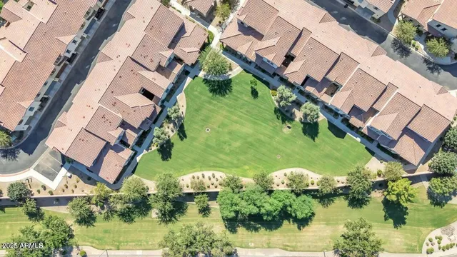 an aerial view of residential houses with outdoor space and ocean view