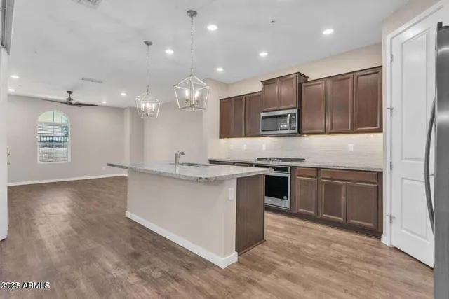 a view of a kitchen with a sink and a refrigerator