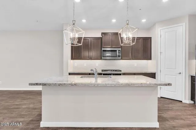a view of a kitchen with a sink and a refrigerator
