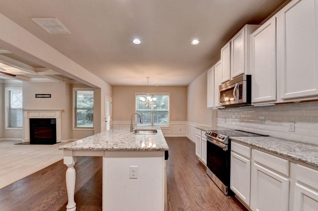 5166 Apple Grove Road Northeast Buford, GA 30519 - Photo 11 of 29 a kitchen with granite countertop counter space a sink stainless steel appliances and cabinets