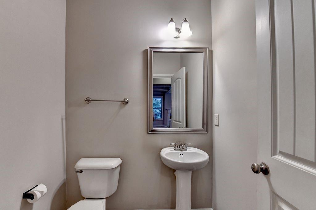 5166 Apple Grove Road Northeast Buford, GA 30519 - Photo 13 of 29 a bathroom with a toilet sink and mirror