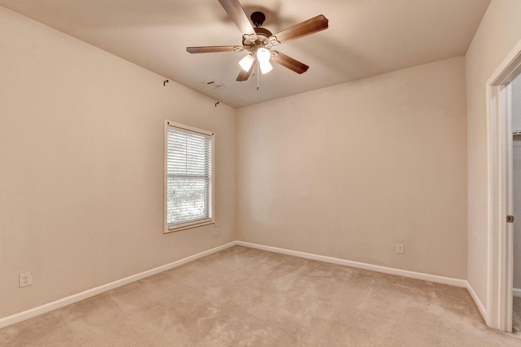 5166 Apple Grove Road Northeast Buford, GA 30519 - Photo 16 of 29 an empty room with windows and fan